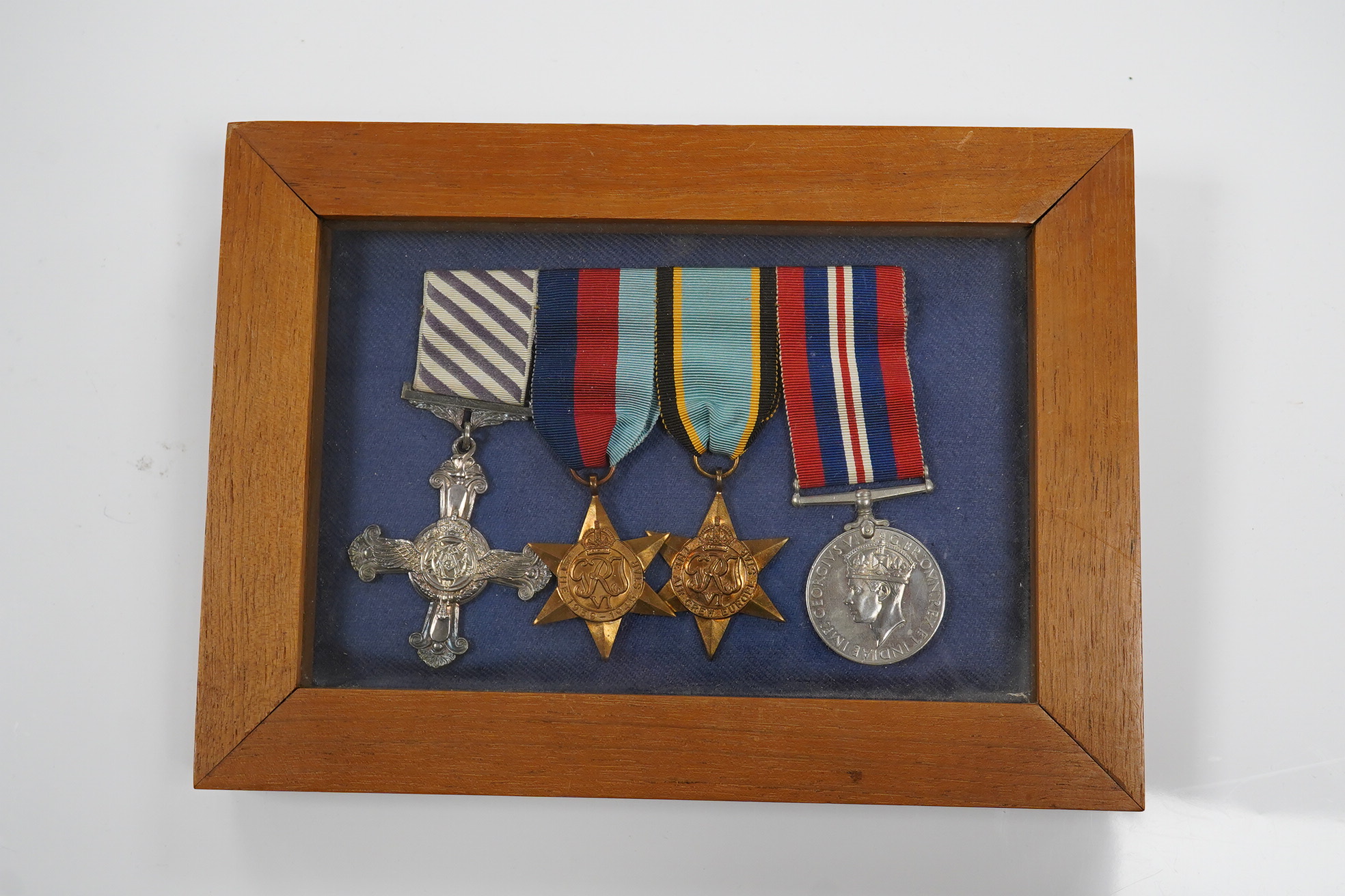 A DFC medal group with an Air Crew Europe star in a display case. Condition - good